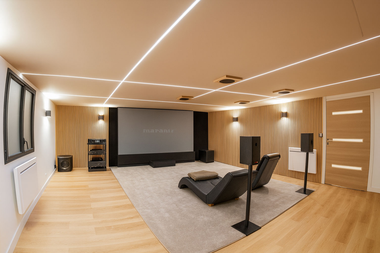 Salon cinéma contemporain avec parquet en chêne, moquette grise et deux assises lounge noires